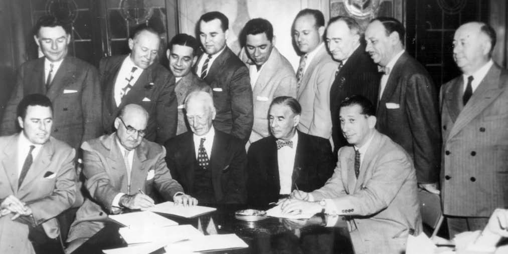 affixes his signature to an agreement selling the Athletics to the Philadelphia syndicate on October 17, 1954—a commitment Roy would betray just a day later in a backroom deal with Arnold Johnson.