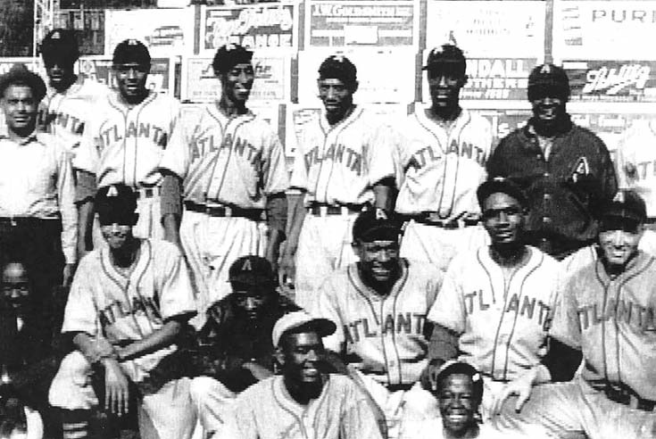 Red Moore (in lower right corner) stands with his teammates.
