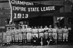 Past and present members of the Thomasville Hornets pose with the team’s Empire State League pennant before the start of the 1914 season. Standing, left to right: Mitchell Davenport, Klump, Harry Champlin, “Red” Murch, Mabry, Manager Martin Dudley, Hal Barnett, George Wilkes, Hall, Vincent Roth, “Professor” Day, Schultz, Ealen, Telken, Kane. Front row, left to right: E. R. Jerger, Club Secretary; R. G. Mays, club president (1914); J. B. Jemison, club president (1913).