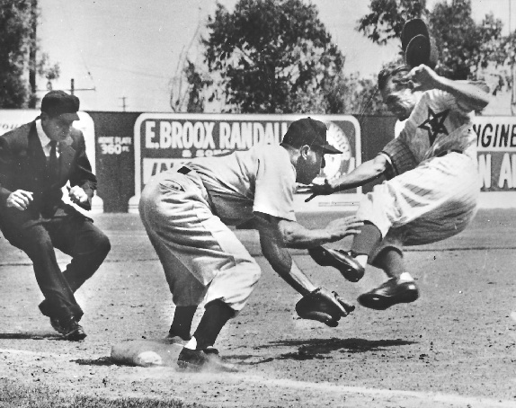 The trigger for the biggest brawl in PCL history. Hollywood Stars outfielder Ted Beard slides spikes-high into Los Angeles Angels third baseman Murray Franklin, August 2, 1953.