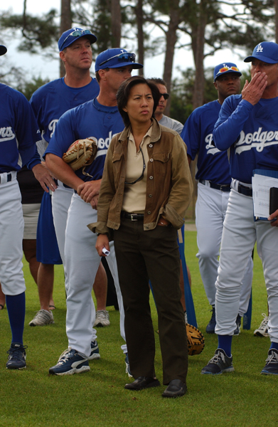 Dodgers players tower over the 5-foot-2-inch Ng as she listens during a spring training meeting in Vero Beach, Florida.