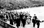 Boston fans march onto the field before a game during the 1903 World Series.