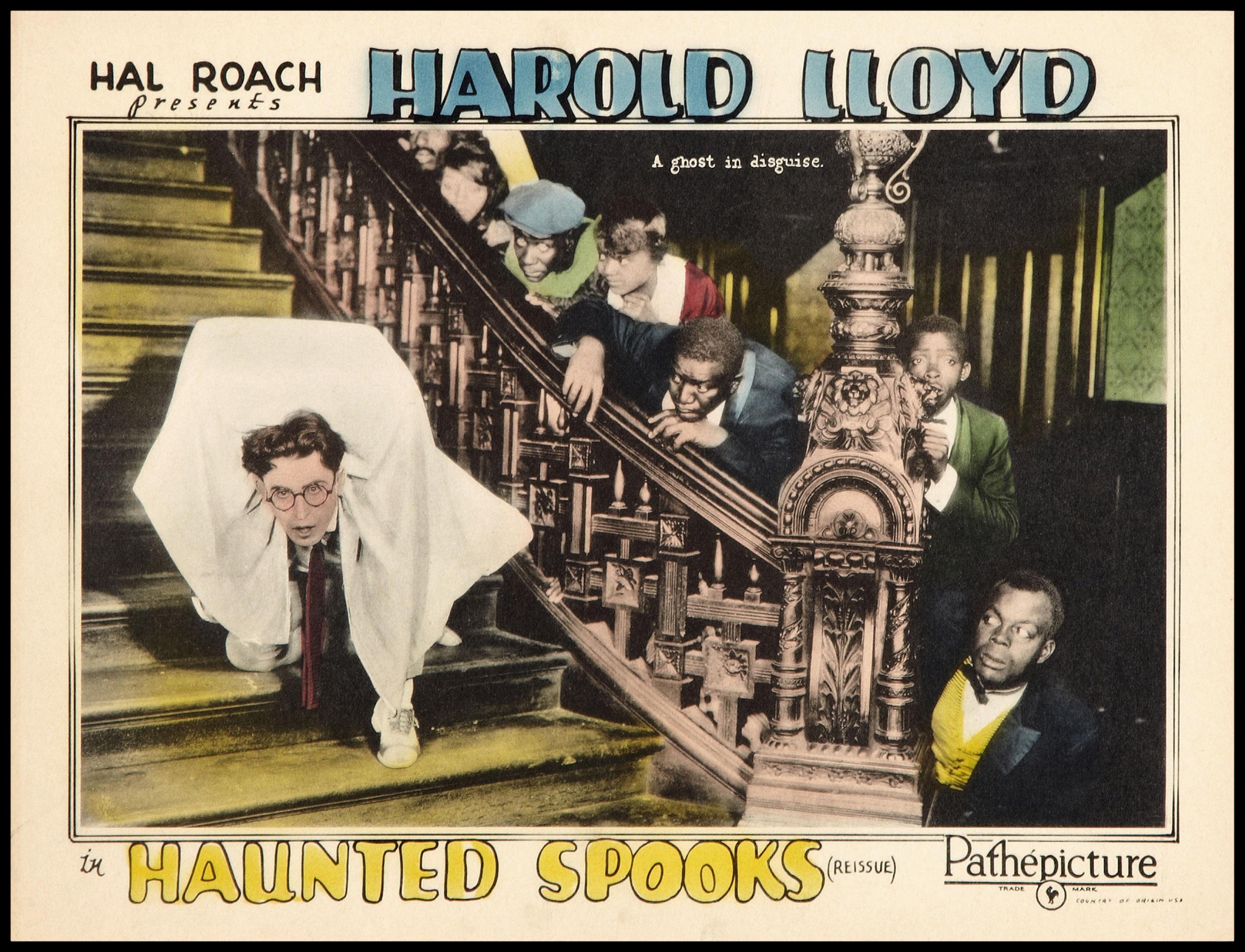 Haunted Spooks (1920) reissue lobby card – A ghost in disguise – featuring Harold Lloyd (as the Boy) tangled in bed sheet and Edgar Blue (as the Butler) gazing from the foot of staircase.