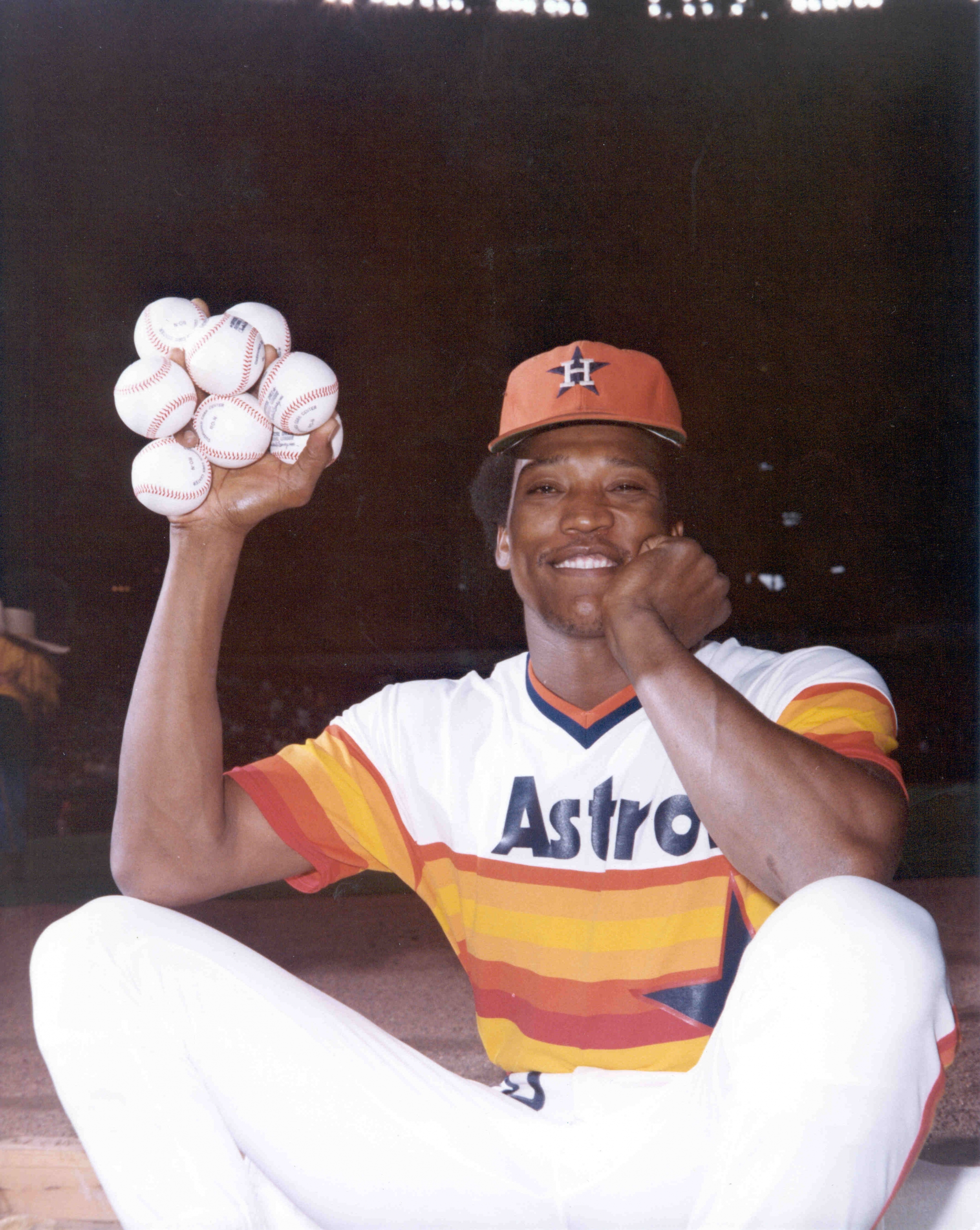 At the peak of his career, holding eight baseballs with his enormous pitching hand.